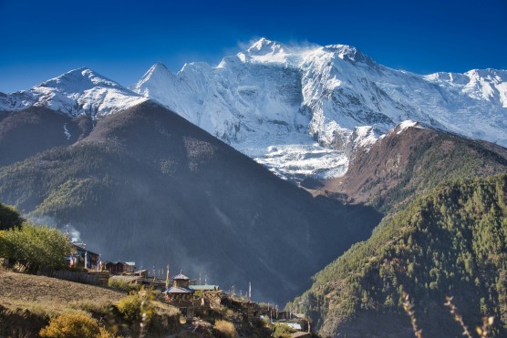 Majestic Annapurna Peaks Amidst Clear Blue Skies